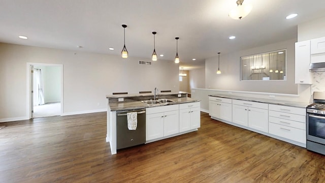 kitchen with dark wood-type flooring, white cabinets, a sink, and stainless steel appliances