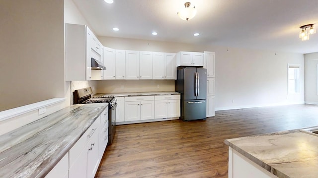 kitchen featuring dark wood-type flooring, under cabinet range hood, white cabinetry, and stainless steel appliances