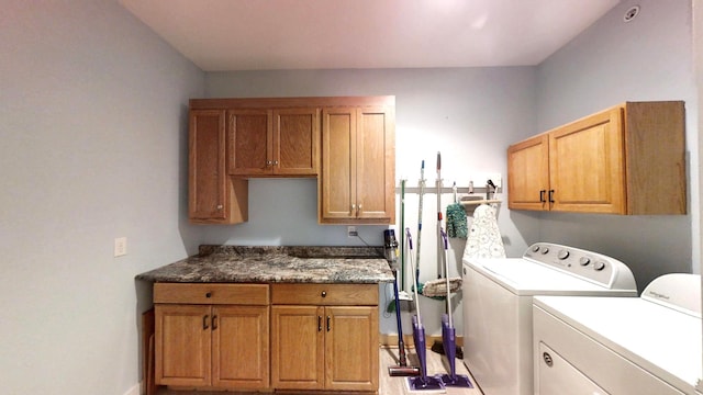 laundry area featuring washing machine and clothes dryer and cabinet space