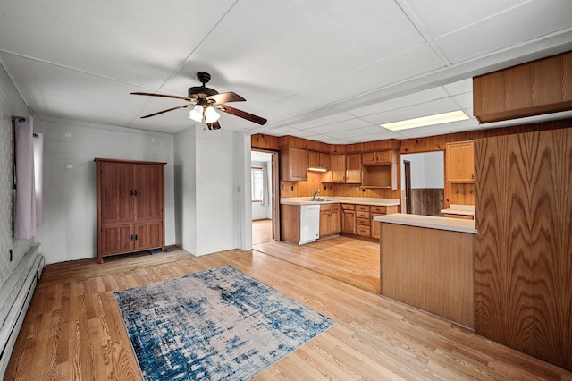 kitchen featuring a sink, baseboard heating, white dishwasher, light wood-style floors, and ceiling fan