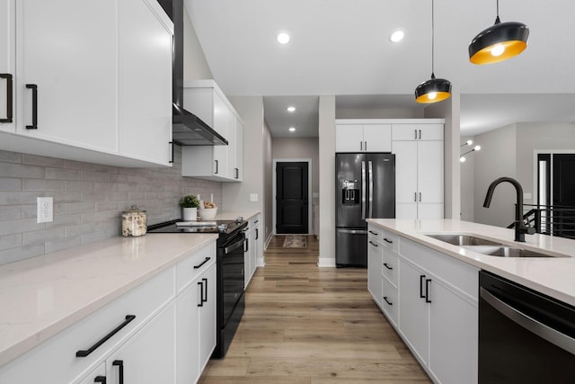 kitchen featuring black electric range, fridge with ice dispenser, a sink, dishwasher, and hanging light fixtures