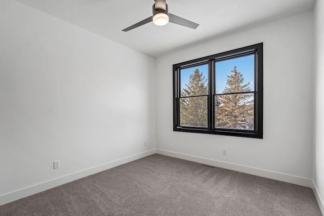spare room featuring carpet floors, baseboards, and a ceiling fan