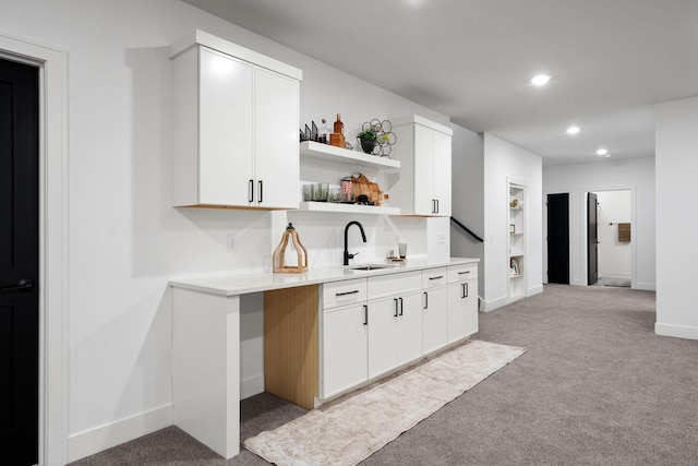 indoor wet bar with light colored carpet, recessed lighting, and baseboards