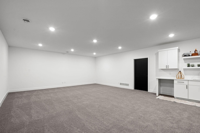 interior space with recessed lighting, carpet flooring, baseboards, and a sink