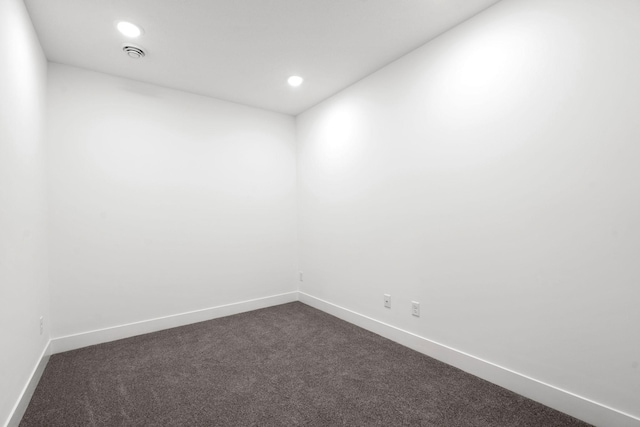 unfurnished room featuring dark colored carpet, baseboards, and recessed lighting
