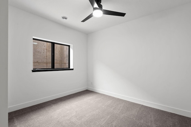 empty room with carpet floors, ceiling fan, and baseboards