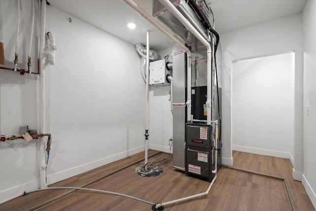 utility room featuring heating unit