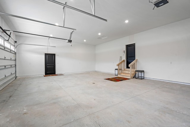 garage with a garage door opener, recessed lighting, and baseboards