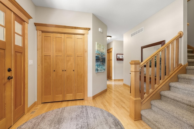 1301 Pondview Ln, Saint Joseph, MN 56374 - foyer featuring baseboards, stairs, wood finished floors, and visible vents