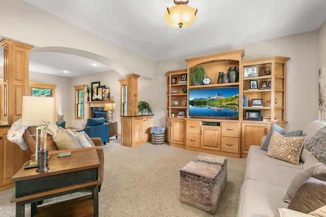 1301 Pondview Ln, Saint Joseph, MN 56374 - carpeted living area with arched walkways, a fireplace, and decorative columns