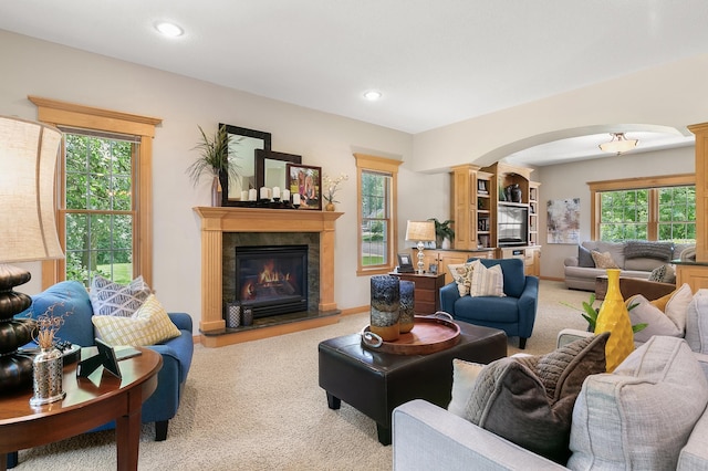 1301 Pondview Ln, Saint Joseph, MN 56374 - living room featuring arched walkways, carpet, and decorative columns