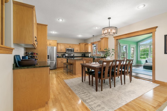 1301 Pondview Ln, Saint Joseph, MN 56374 - dining space with baseboards, recessed lighting, light wood-style flooring, and a notable chandelier