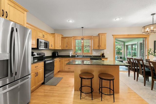 1301 Pondview Ln, Saint Joseph, MN 56374 - kitchen with appliances with stainless steel finishes, a kitchen island, and light brown cabinets