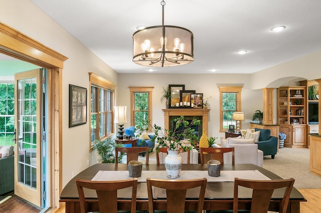 1301 Pondview Ln, Saint Joseph, MN 56374 - dining area featuring recessed lighting, light wood-style flooring, a notable chandelier, and a fireplace