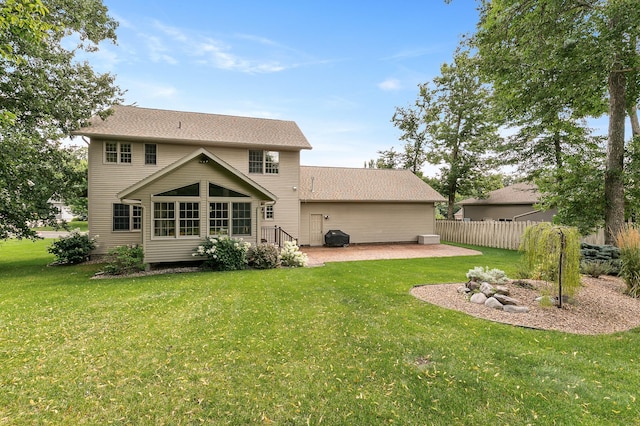 1301 Pondview Ln, Saint Joseph, MN 56374 - back of property featuring a patio, a lawn, fence, and roof with shingles