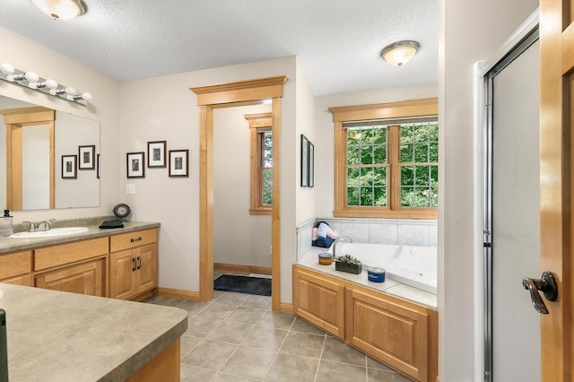 1301 Pondview Ln, Saint Joseph, MN 56374 - bathroom featuring vanity, baseboards, a textured ceiling, tile patterned floors, and a bath