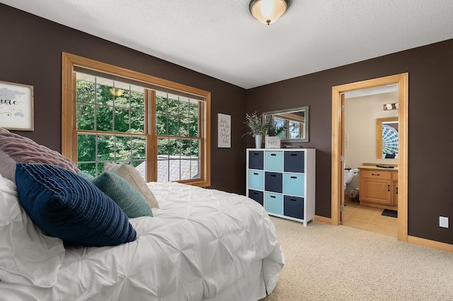 1301 Pondview Ln, Saint Joseph, MN 56374 - bedroom featuring baseboards, light carpet, a textured ceiling, and connected bathroom