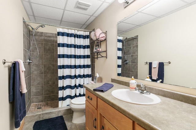 1301 Pondview Ln, Saint Joseph, MN 56374 - bathroom featuring a paneled ceiling, a tile shower, vanity, tile patterned floors, and toilet