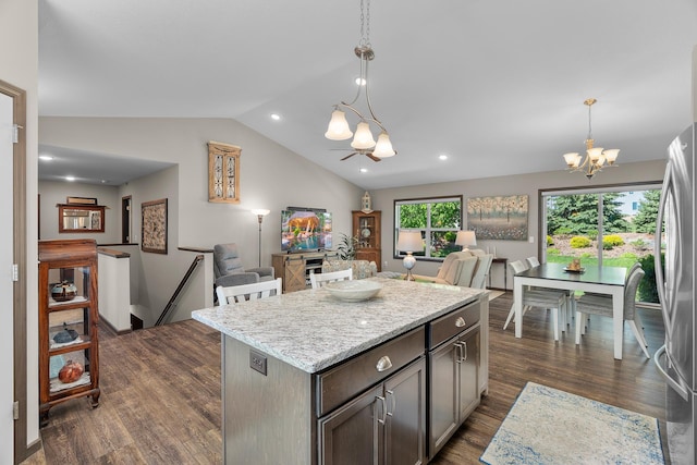 5234 Sundial Ln, Woodbury, MN 55129 - kitchen featuring a chandelier, lofted ceiling, dark wood-style floors, freestanding refrigerator, and a kitchen island