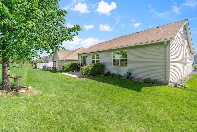 5234 Sundial Ln, Woodbury, MN 55129 - rear view of house featuring a yard and roof with shingles