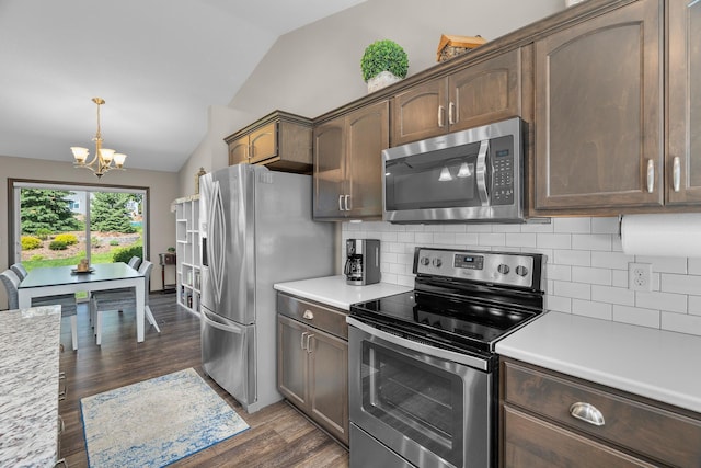 5234 Sundial Ln, Woodbury, MN 55129 - kitchen with stainless steel appliances, vaulted ceiling, a chandelier, and light countertops