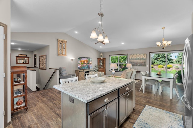 5234 Sundial Ln, Woodbury, MN 55129 - kitchen featuring a chandelier, vaulted ceiling, dark wood-type flooring, freestanding refrigerator, and a kitchen island
