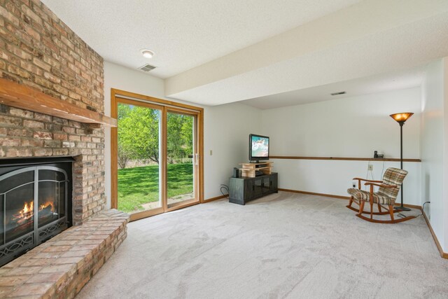 unfurnished room with carpet flooring, baseboards, a brick fireplace, and a textured ceiling