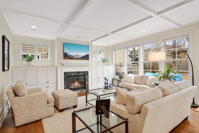living area with coffered ceiling, beam ceiling, a premium fireplace, dark wood finished floors, and recessed lighting