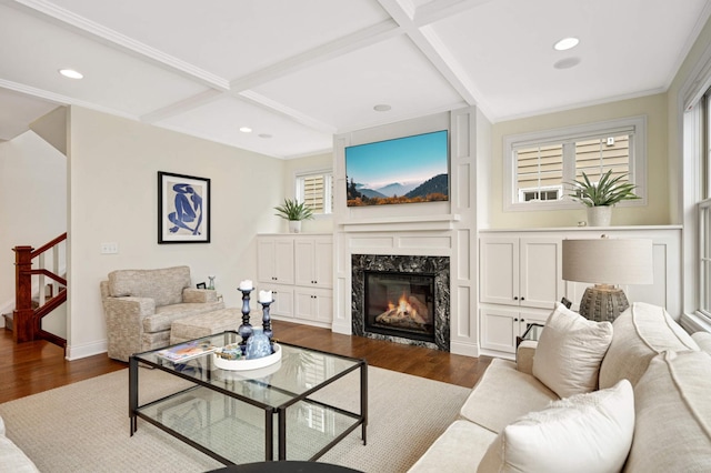 living area featuring a high end fireplace, dark wood-style flooring, coffered ceiling, and recessed lighting