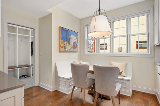 dining room with dark wood-style floors and baseboards