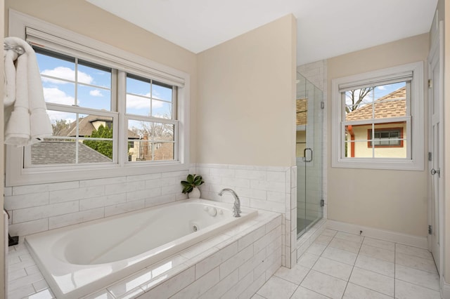 bathroom featuring tile patterned flooring, plenty of natural light, a stall shower, and a garden tub