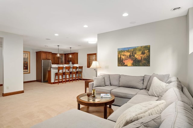 living area with recessed lighting, light carpet, baseboards, and visible vents