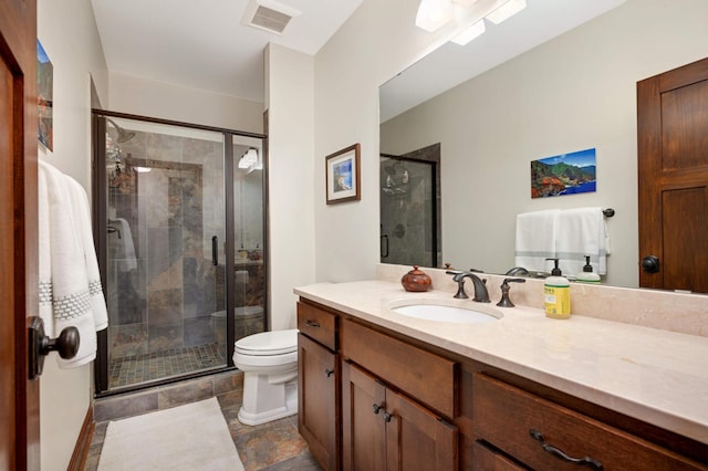 bathroom featuring a stall shower, visible vents, toilet, and vanity