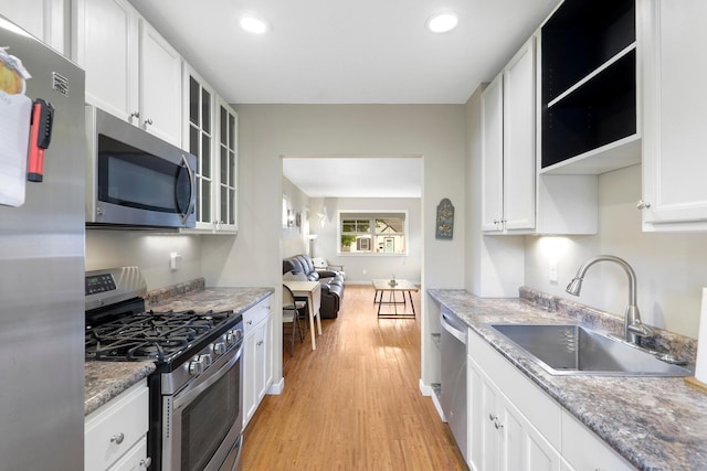 5441 44th Ave S, Minneapolis, MN 55417 - kitchen featuring stainless steel appliances, light wood-type flooring, white cabinetry, recessed lighting, and glass insert cabinets