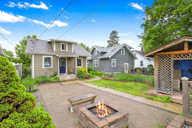 5441 44th Ave S, Minneapolis, MN 55417 - rear view of property featuring a fire pit, a patio area, and a shingled roof