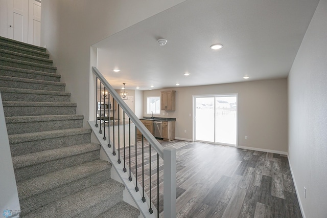 8072 Goldfinch Dr, Horace, ND 58047 - stairs with wood finished floors, baseboards, recessed lighting, and a chandelier