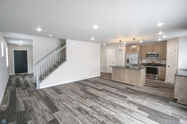 8072 Goldfinch Dr, Horace, ND 58047 - kitchen with appliances with stainless steel finishes, a kitchen island, dark wood-style flooring, dark countertops, and recessed lighting