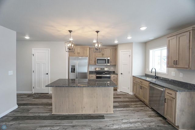 8072 Goldfinch Dr, Horace, ND 58047 - kitchen with stainless steel appliances, a sink, dark wood-style flooring, a kitchen island, and dark stone countertops