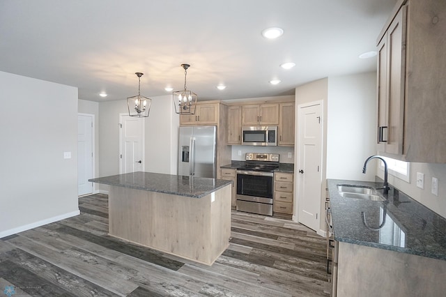 8072 Goldfinch Dr, Horace, ND 58047 - kitchen featuring stainless steel appliances, a sink, light brown cabinets, dark wood finished floors, and a center island