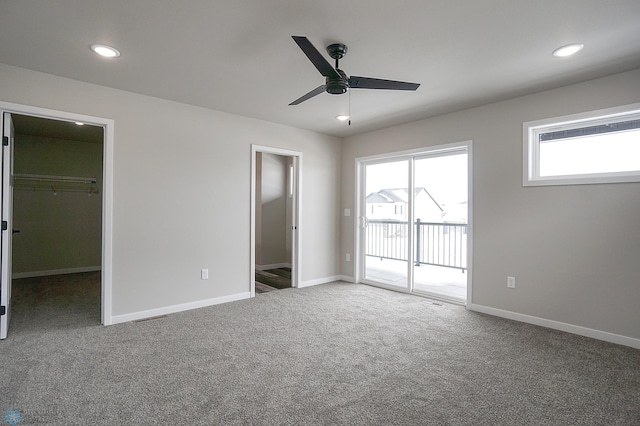 8072 Goldfinch Dr, Horace, ND 58047 - unfurnished bedroom featuring access to outside, a walk in closet, carpet flooring, baseboards, and recessed lighting