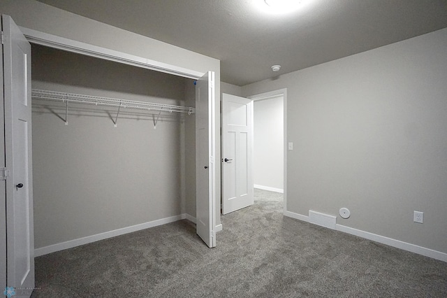 8072 Goldfinch Dr, Horace, ND 58047 - unfurnished bedroom with carpet flooring, a closet, and baseboards