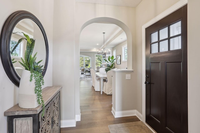 3729 Queensland Ln N, Plymouth, MN 55446 - entrance foyer featuring baseboards, arched walkways, a chandelier, and dark wood-style flooring