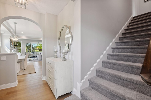 3725 Queensland Ln N, Plymouth, MN 55446 - staircase featuring arched walkways, baseboards, and wood finished floors