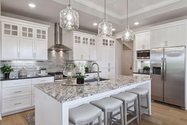 3725 Queensland Ln N, Plymouth, MN 55446 - kitchen featuring light wood-style flooring, wall chimney range hood, ornamental molding, and appliances with stainless steel finishes