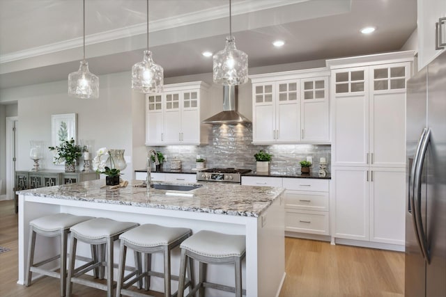 3725 Queensland Ln N, Plymouth, MN 55446 - kitchen with light wood finished floors, wall chimney exhaust hood, backsplash, and appliances with stainless steel finishes