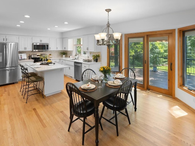 8118 Currant Pl, Eden Prairie, MN 55347 - dining area with light wood finished floors, a chandelier, and recessed lighting