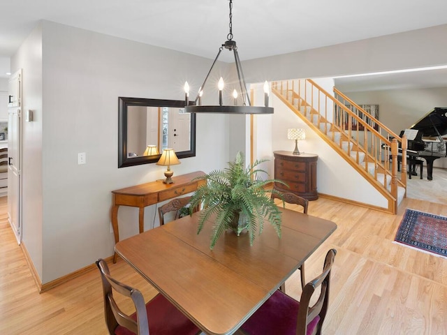8118 Currant Pl, Eden Prairie, MN 55347 - dining room featuring wood finished floors, stairway, and a chandelier