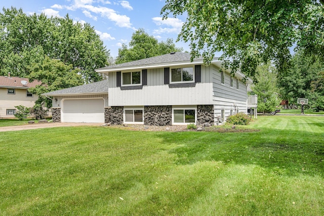 8211 6th St NE, Spring Lake Park, MN 55432 - split level home with stone siding, a front lawn, concrete driveway, and a garage