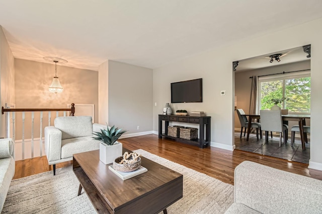 4 Battle Creek Ct, Saint Paul, MN 55119 - living area featuring wood finished floors, a chandelier, and baseboards