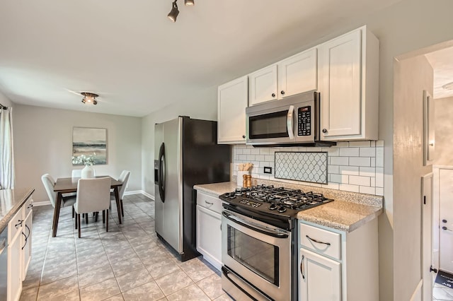 4 Battle Creek Ct, Saint Paul, MN 55119 - kitchen with appliances with stainless steel finishes, decorative backsplash, white cabinets, and baseboards